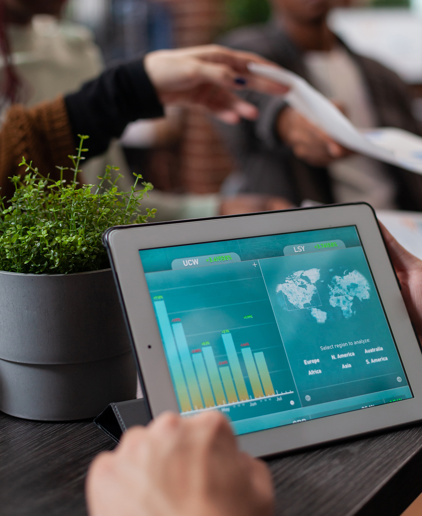Closeup of entrepreneur holding tablet computer with marketing statistics
